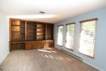 Front bedroom with closet - currently serving as office with built in cabinets.