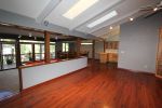 The main area features a two tier living room adjacent to dining and kitchen.